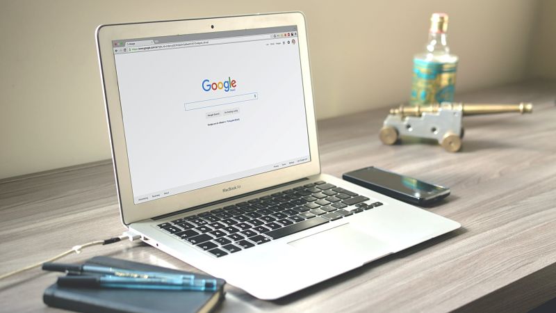 Laptop on desk with Google homepage open